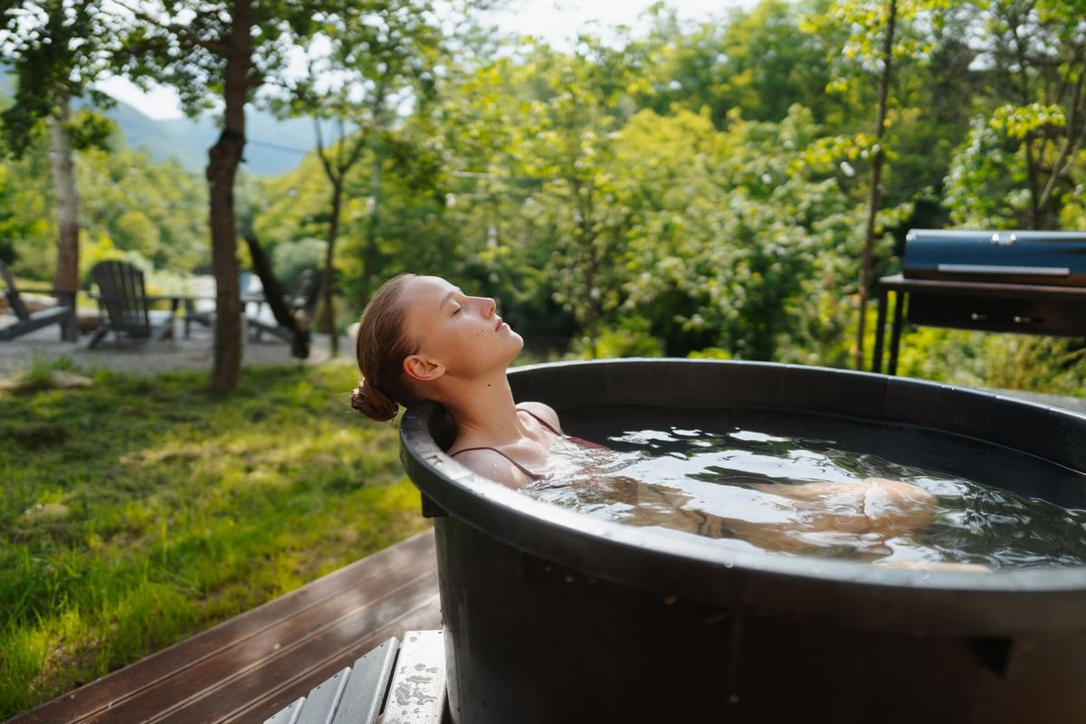 Luxury cold plunge tub in a modern wellness space, filled with crystal-clear water chilled to optimal recovery temperature, designed for athletic recovery and mental performance boosting