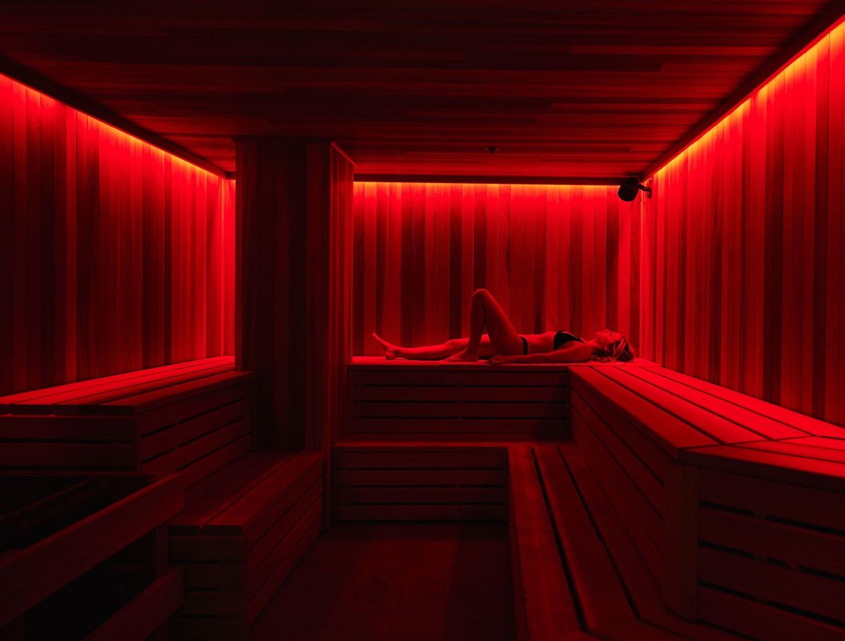 Person relaxing in a Biohackn full spectrum infrared sauna for detox, recovery, and stress relief