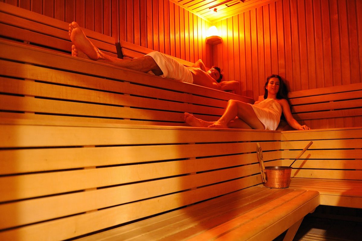 Biohackn full-spectrum infrared sauna in a modern Dubai villa bathroom, showing calming ambient light and wooden interior.